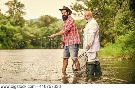 Money Attracting Ideas. Friends Men With Fishing Rod And Net. Retired Dad And Mature Bearded Son. Ha