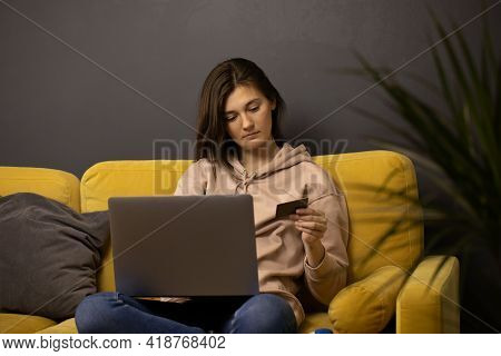 Girl Makes Purchases Or Payments Online, Looks At Credit Card Cvv Security Code