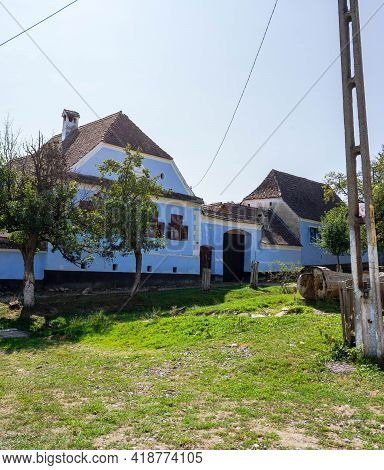 View Of Picturesque Village Viscri In Romania. Painted Traditional Old Houses In Medieval Saxon Vill