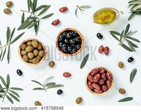Set Of Green Olives, Black Olives And Red Kalmata Olives And Extra Virgin Olive Oil On White Backgro