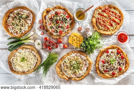 A Close Up A Set Of Hungarian Traditional Langos With Crusty Garlic Edges Served With Vegetables, Cr