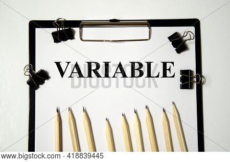 The Variable The Word Is Written On A White Piece Of Paper With Pencils. Word