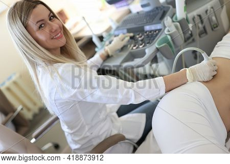 Woman Doctor Doing Ultrasound Examination Of Kidneys To Female Patient In Clinic