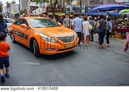Seoul, South Korea - 1 June 2014, The Orange Taxi Is Driven In The Holiday Walking Street Event, Seo