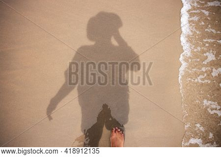 Photographer Taking Self Portrait By Reflection Shadow On Beach Sand. Top View. Summer Vacation. Har