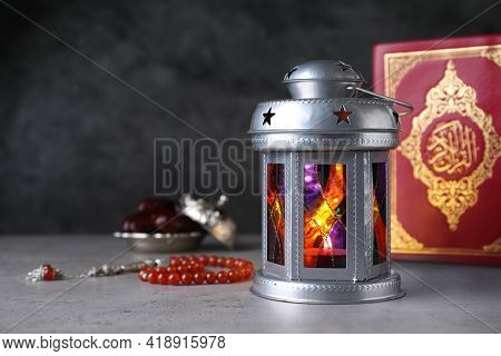 Arabic Lantern, Quran And Misbaha On Grey Table. Space For Text