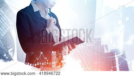 Businesswoman Checking Notes In Notebook. Digital Graph Of Stock Market Changes. Double Exposure Of 