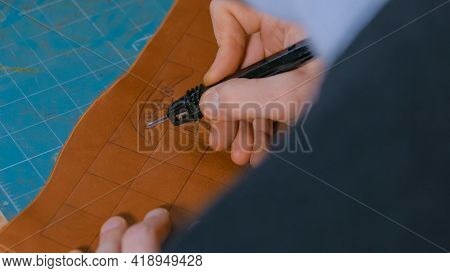 Professional Male Skinner, Tanner Making Decorative Details On Leather Playing Field For Strategy Bo