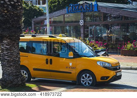Alanya, Turkey  - April 13  2021: Yellow Taxi Fiat Doblo    Is Parked  On The Street On A Warm Summe