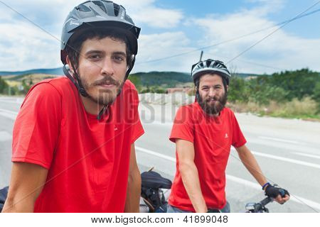 MOSTAR, BOSNIA - AUGUST 14: Young cyclist touring from Madrid to Istanbul on August 14, 2012 near Mostar, Bosnia. A growing number of eco-travellers tour by bike to lessen their carbon footprint.