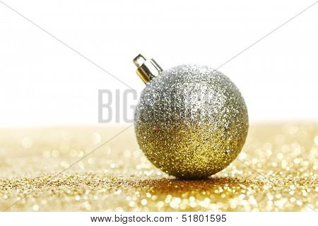 Silver christmas ball on shiny golden background
