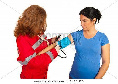 Paramedic Measure Blood Pressure To Woman