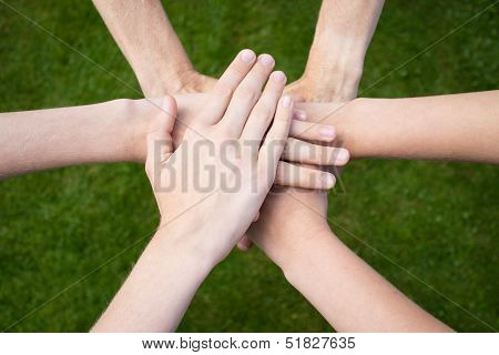 Arms uniting above grass