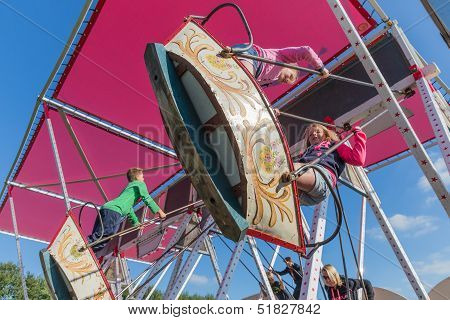 Nieuwehorne, The Netherlands - Sep 28: Fair With Unknown Children At A Wooden Swing During The Agric