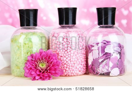Aromatherapy minerals - colorful bath salt on pink background