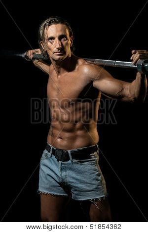 Bodybuilder Exercising Isolated On Black Background