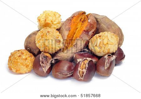 some panellets and roasted chestnuts and sweet potatoes, typical snack in All Saints Day in Catalonia, Spain, on a white background