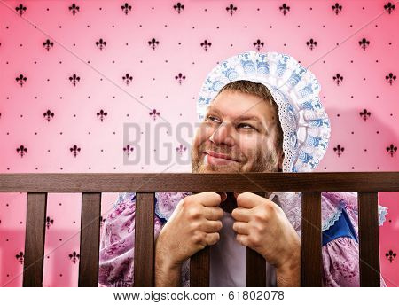 Adult man in playpen looking out