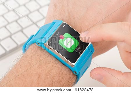 Finger Taps Messenger Icon On Blue Smart Watch
