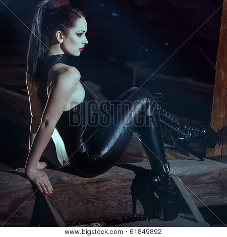 Sexy Woman Sit On Timber At Night