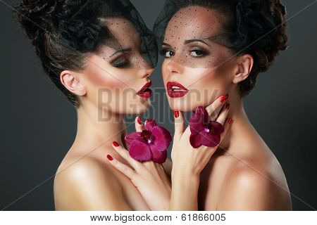 Flirt. Portrait Of Two Voluptuous Romantic Women With Violet Orchids