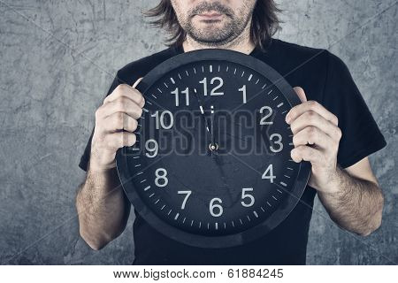 Man Holding Big Black Clock