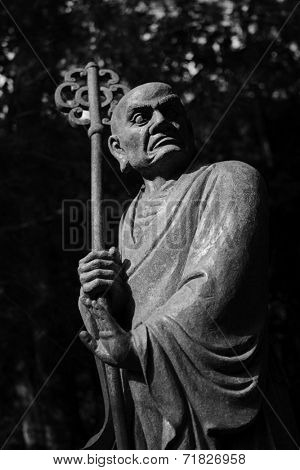 Old ruined Arhat Kanakbharadvaja statue in forest, Taiwan, Asia.