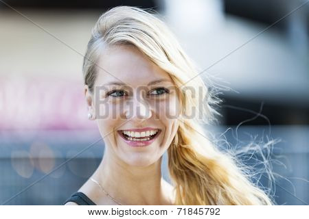 Candid portrait of young blonde woman laughing