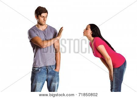 Man rebuffing the kiss of his girlfriend on white background