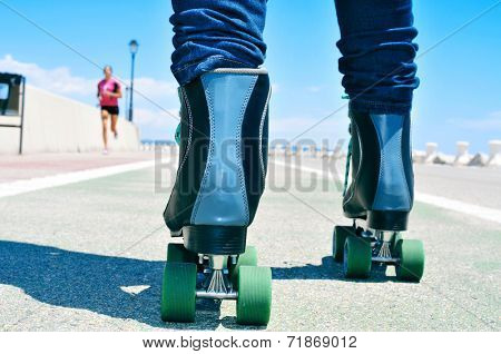 closeup of a young man roller skating on a no traffic road