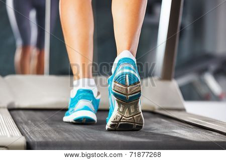 Woman Running On Treadmill In Gym.