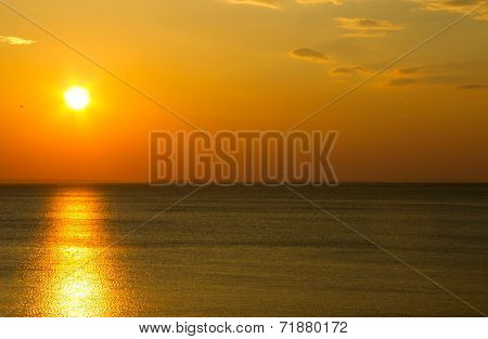 Afterglow Of The Setting Sun Shining Above Sea Level