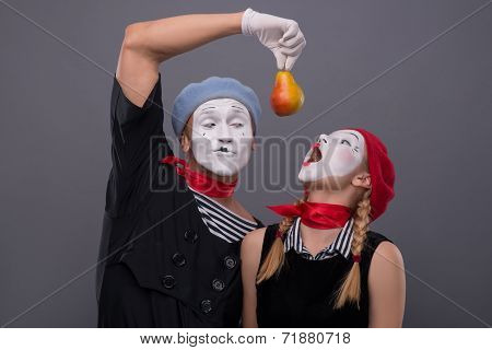 Portrait of funny mime couple with white faces and emotions isol