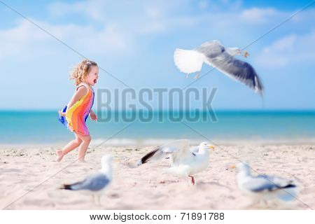 Little Girl Playing With Seagulls