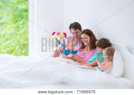Happy Big Family In A Bed