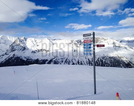 Signpost giving directions to different ski slopes