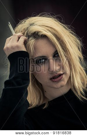Portrait of a frustrated teenage girl with cigarette