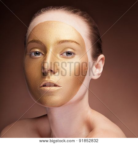 Woman With Gold Face Make Up Fashion On Brown