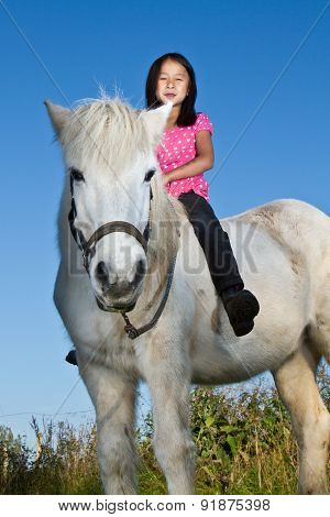 Girl Ridding A White Horse In Denmark