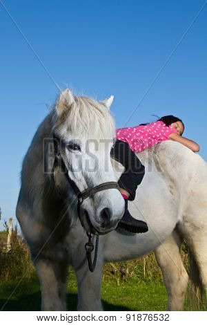 Girl Ridding A White Horse In Denmark