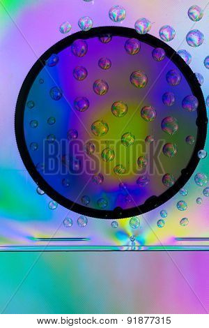 Amazing colors of white light that pass through the clear plastic, water drops and CPL filter.