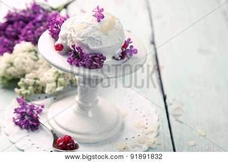Beautiful composition with tasty ice cream and lilac flowers