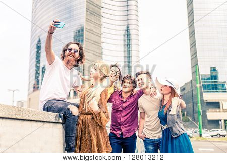 Multi-ethnic group of friends taking a selfie - Several happy people with urban style clotes meeting outdoors and having fun