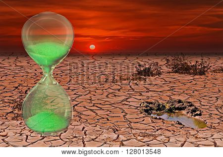 Global warming conceptual composite image with hourglass symbolizing a short time lapse needed for a drastic change in climate of our planet.