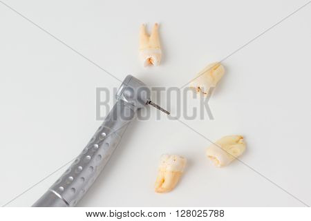 dentist using dental turbine handpiece for dental treatment