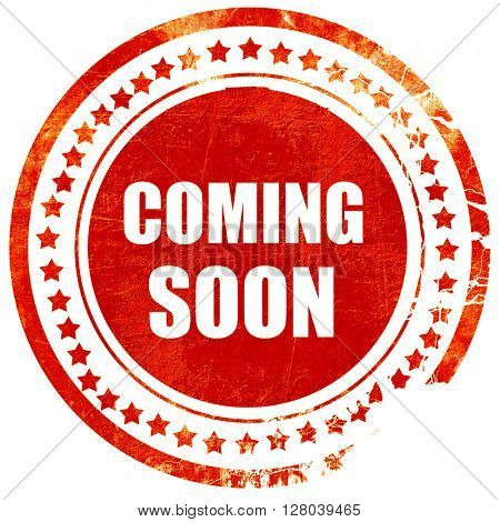 coming soon, grunge red rubber stamp on a solid white background