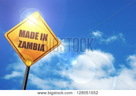 Yellow road sign with a blue sky and white clouds: Made in zambi