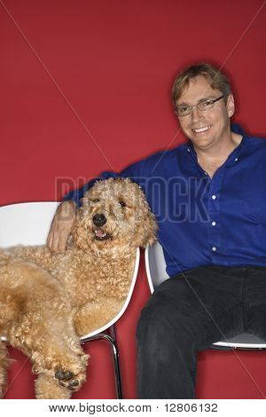 Goldendoodle 犬と一緒に中年の白人の男。