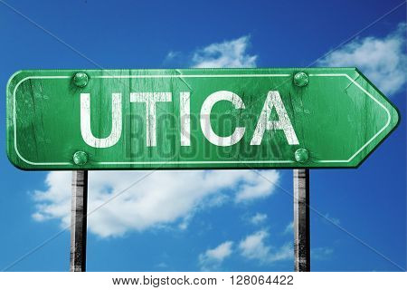 utica road sign , worn and damaged look