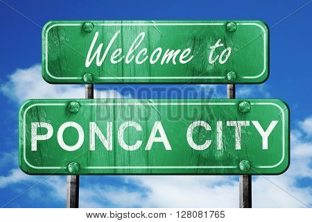 ponca city vintage green road sign with blue sky background